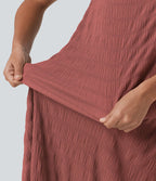 Robe midi sans manches à encolure arrondie avec coussinets amovibles et ourlet à volants