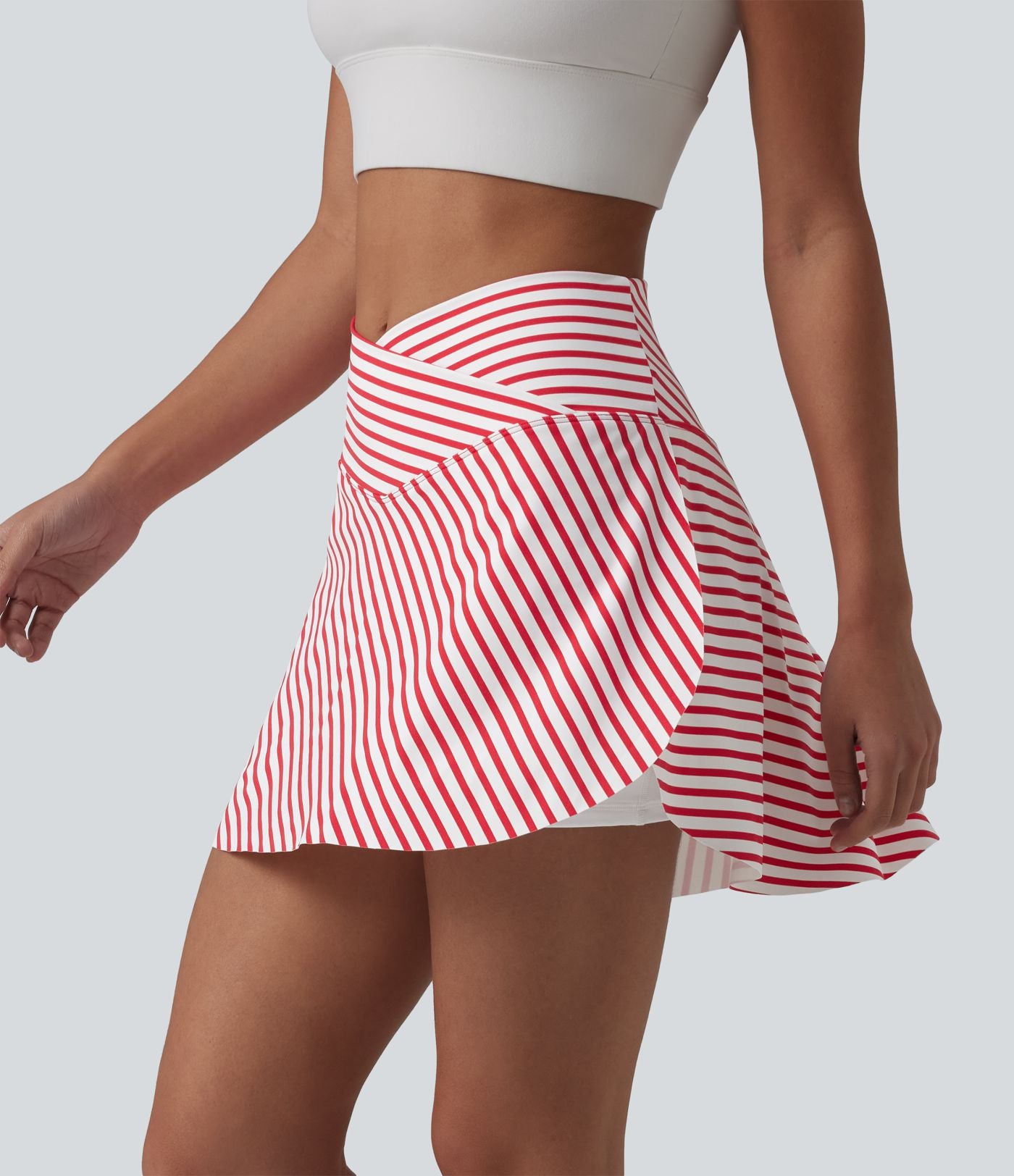 Jupe de tennis mini 2 en 1 à rayures, taille haute croisée, ourlet arrondi et poches