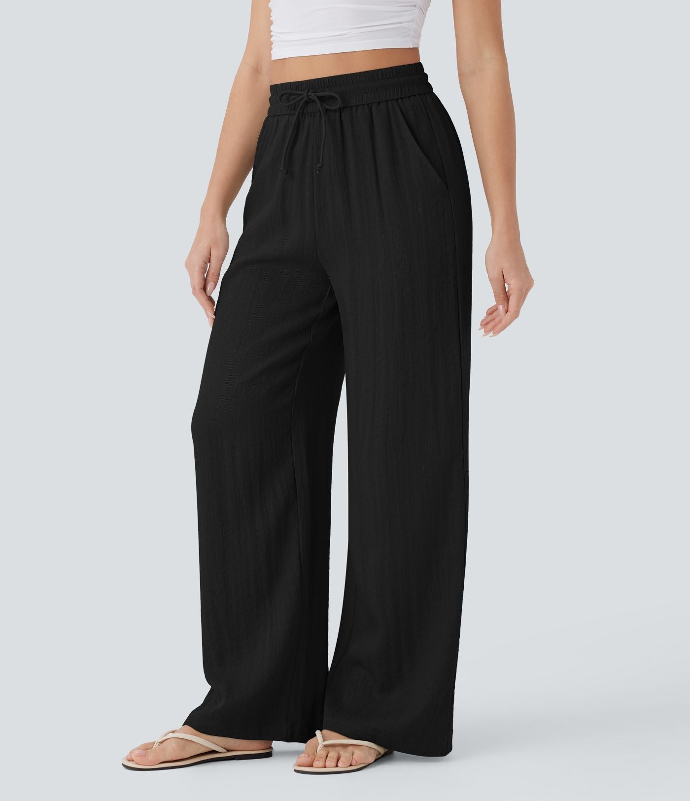 Pantalon large fluide taille haute avec cordon de serrage, poches latérales et aspect lin