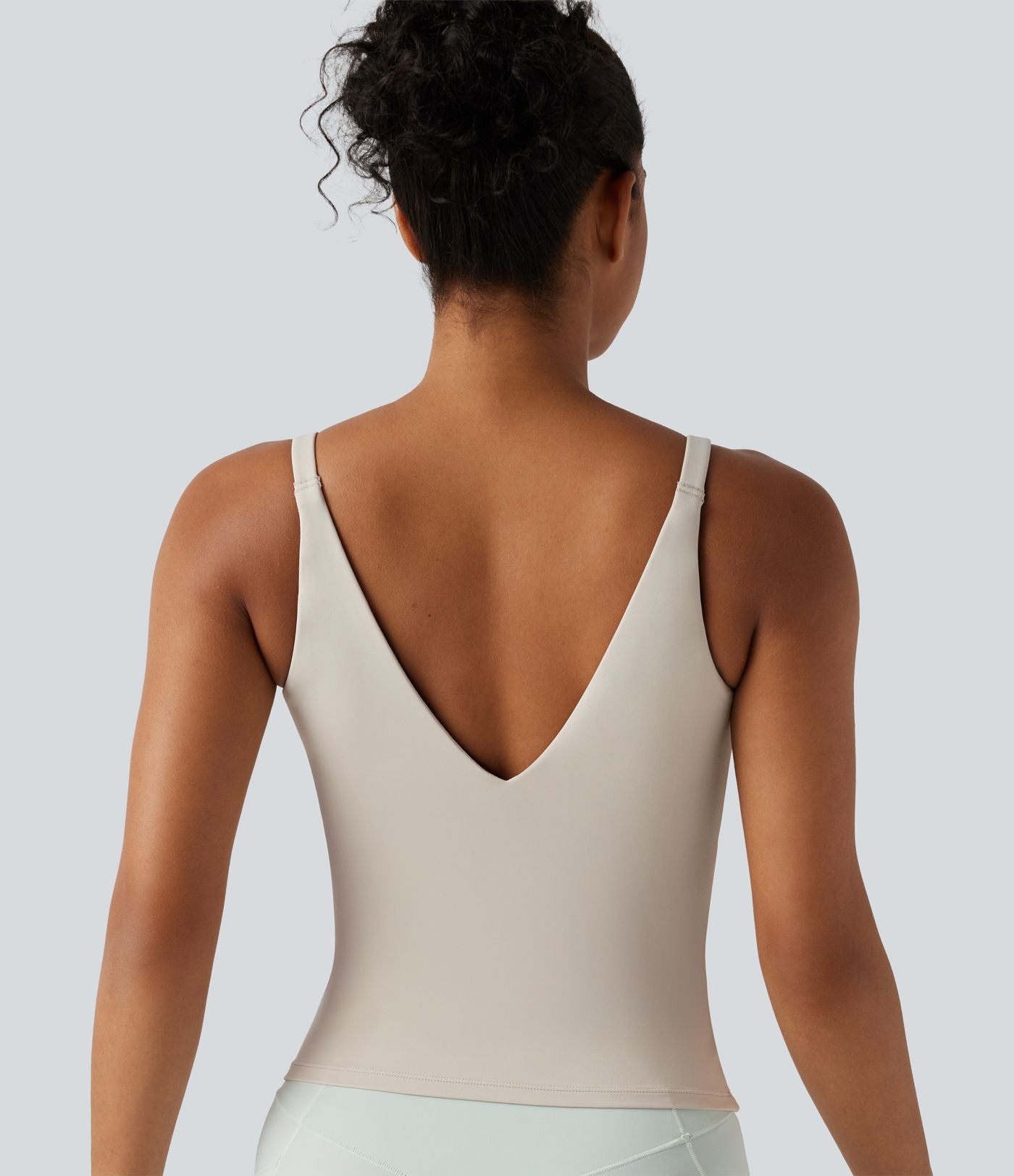 Débardeur de sport effet lissant sous les bras avec dos en V et brassière intégrée