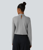Blouse de travail à col montant, plis, boutons au dos et manches longues
