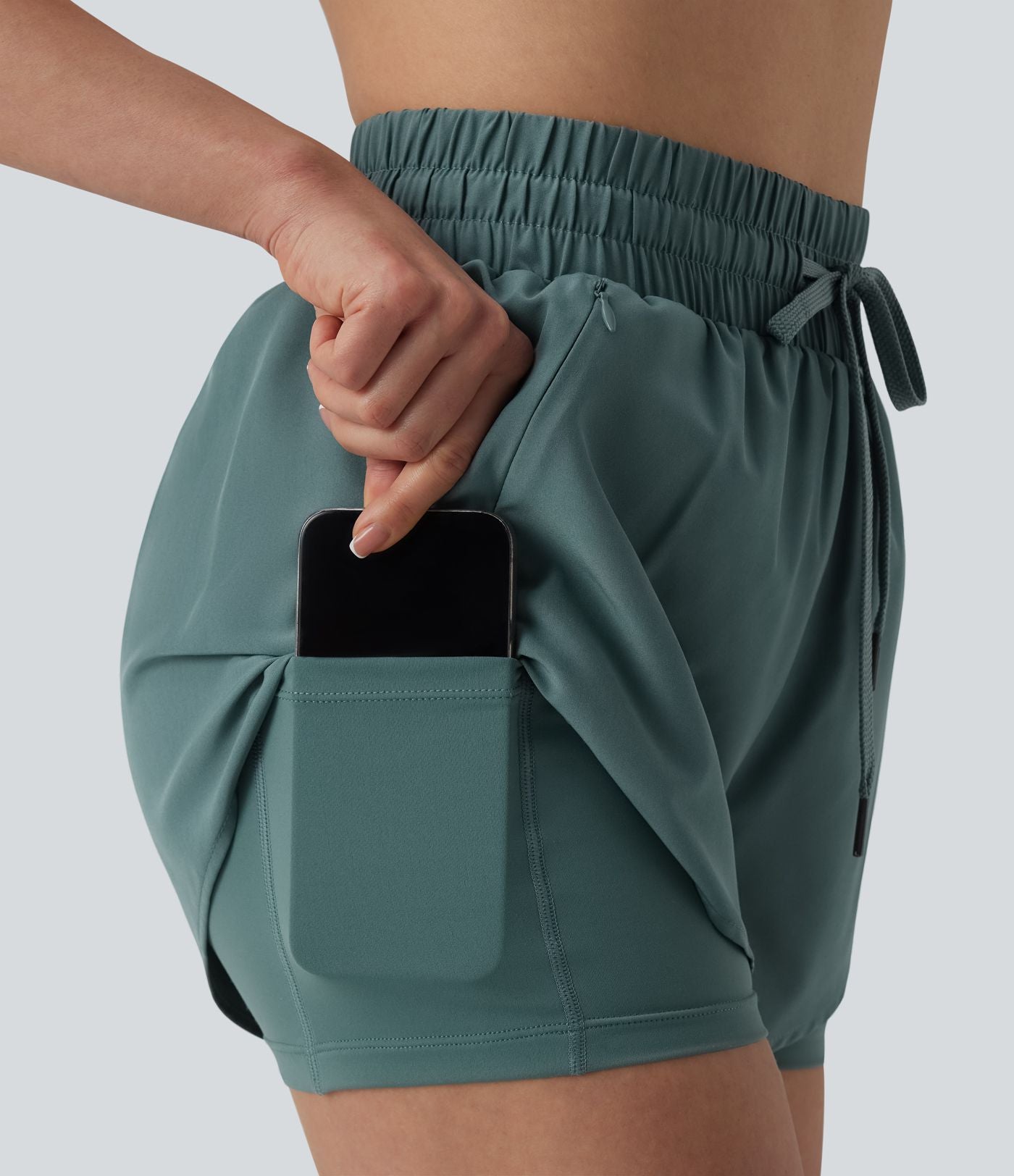 Short running 2-en-1 taille haute avec cordon de serrage et poches