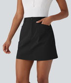 Jupe courte de golf ligne A taille haute avec boutons, zip, poches latérales et fente