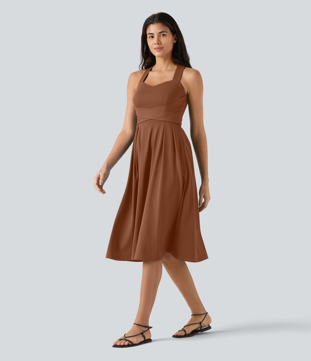 Robe midi fluide sans manches décolleté cœur avec bretelles croisées, nœud dans le dos et poches