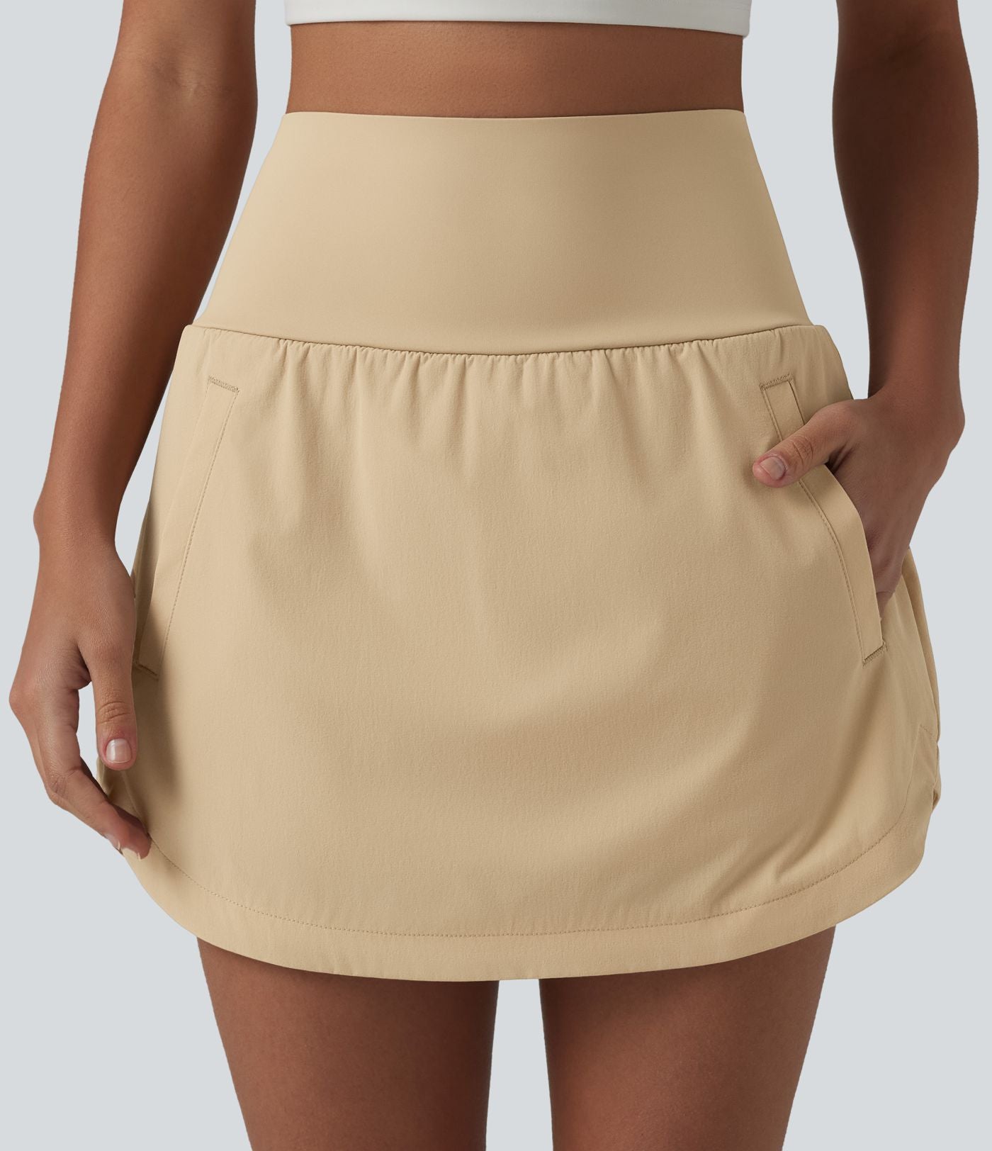 Jupe de golf 2-en-1 taille ultra haute ventre plat avec ourlet arrondi et poches