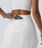 Jupe de golf 2-en-1 taille ultra haute ventre plat avec ourlet arrondi et poches