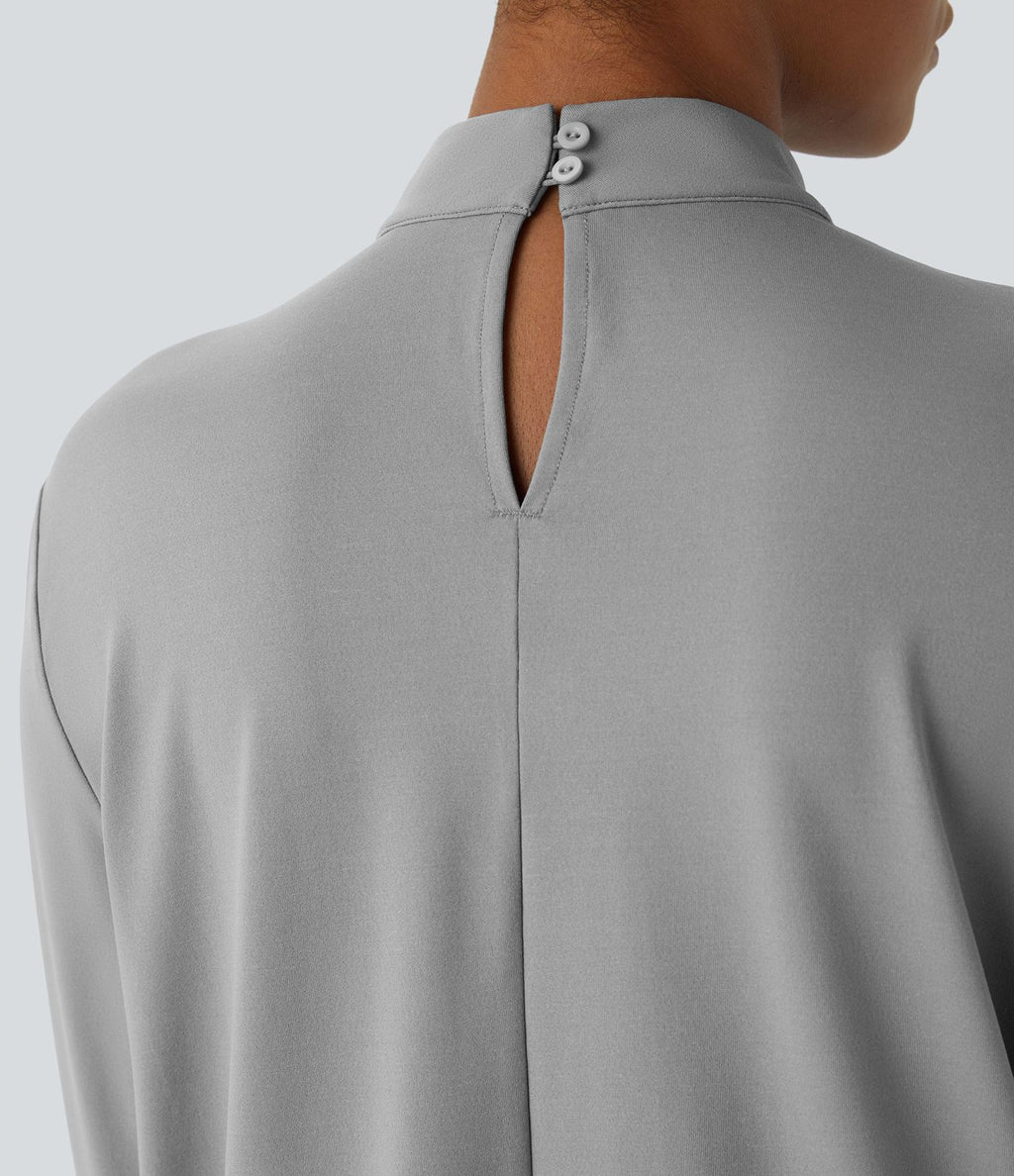 Blouse de travail à col montant, plis, boutons au dos et manches longues