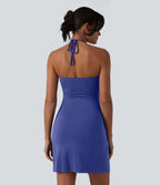 Robe resort mini dos nu à col licou avec lien noué dans le dos et poches