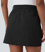 Jupe courte de golf ligne A taille haute avec boutons, zip, poches latérales et fente