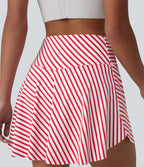 Jupe de tennis mini 2 en 1 à rayures, taille haute croisée, ourlet arrondi et poches