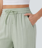 Pantalon large fluide taille haute avec cordon de serrage, poches latérales et aspect lin