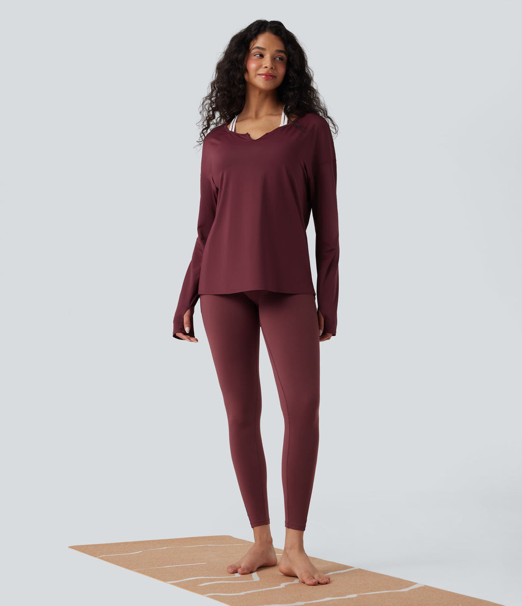 Haut de sport yoga manches longues col cranté à trous pouces, découpes et ourlet asymétrique