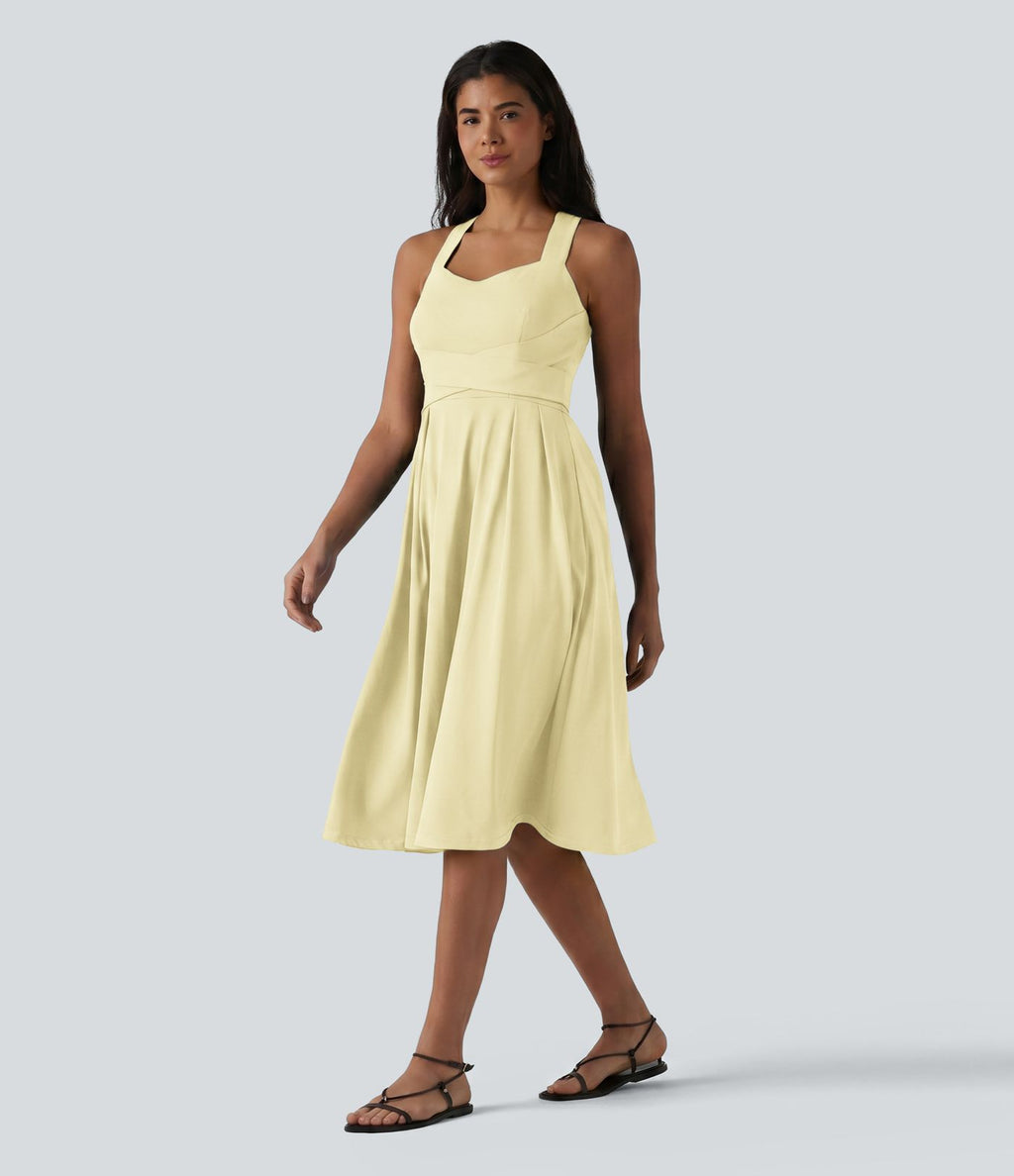 Robe midi fluide sans manches décolleté cœur avec bretelles croisées, nœud dans le dos et poches