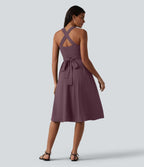 Robe midi fluide sans manches décolleté cœur avec bretelles croisées, nœud dans le dos et poches