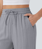 Pantalon large fluide taille haute avec cordon de serrage, poches latérales et aspect lin