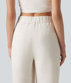 Pantalon large fluide asymétrique taille mi-haute plissé avec poches et aspect lin