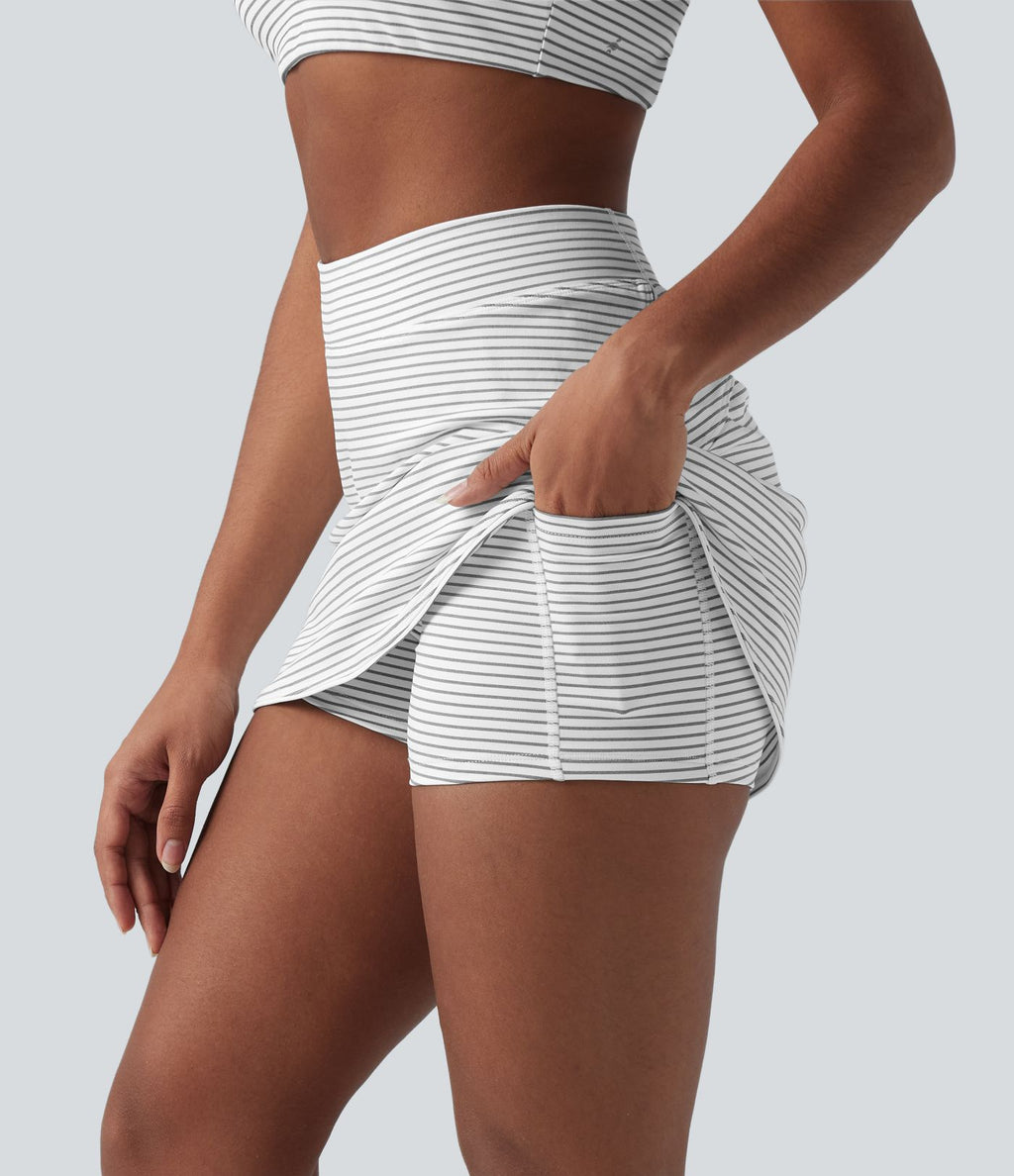 Jupe de golf mini moulante 2-en-1 taille haute à rayures avec poches