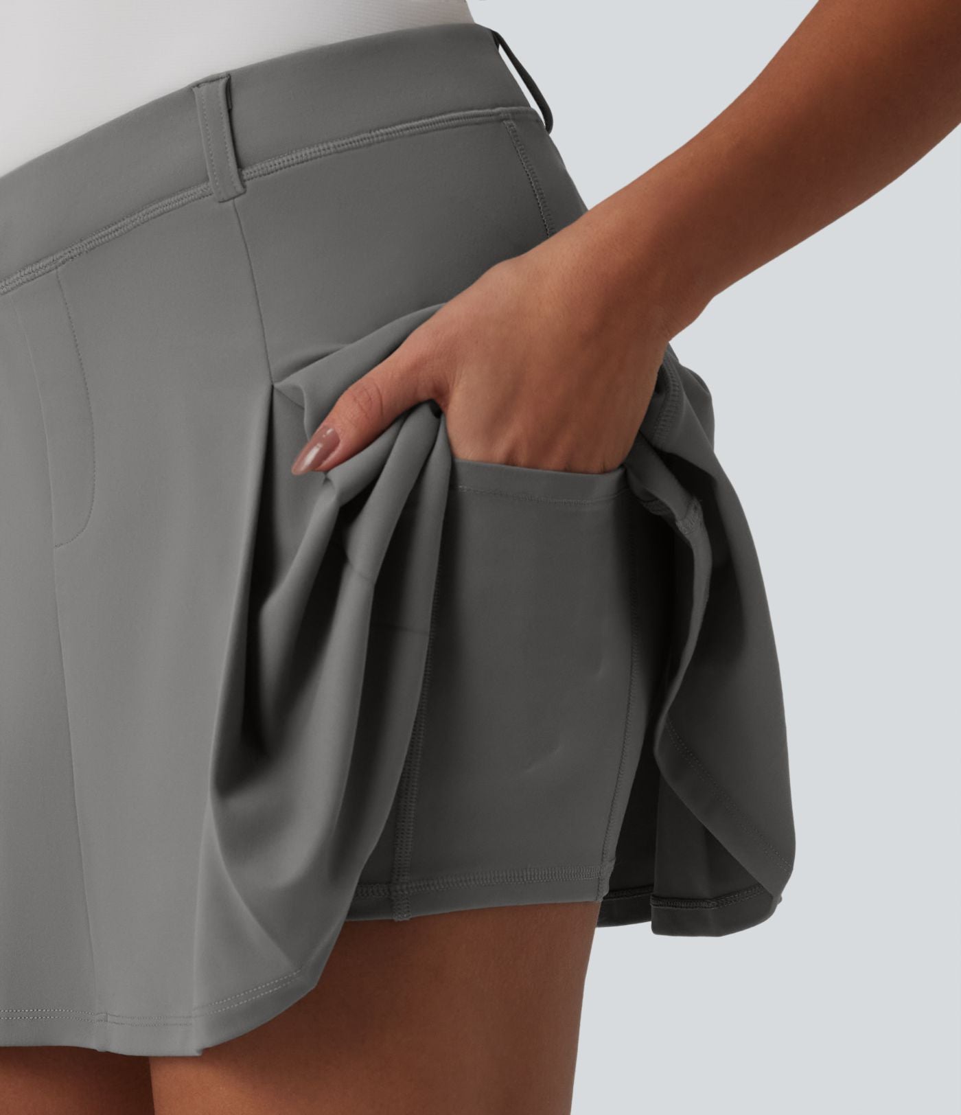 Jupe mini de golf plissée 2-en-1 DayStretch asymétrique taille mi-haute avec poches