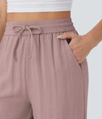 Pantalon large fluide taille haute avec cordon de serrage, poches latérales et aspect lin