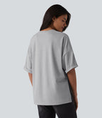 T-shirt décontracté col rond manches retroussées avec ourlet fendu