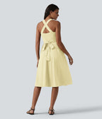 Robe midi fluide sans manches décolleté cœur avec bretelles croisées, nœud dans le dos et poches