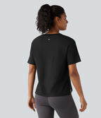 Haut de sport en coton col rond à manches courtes, ourlet fendu et coupe ample pour le yoga