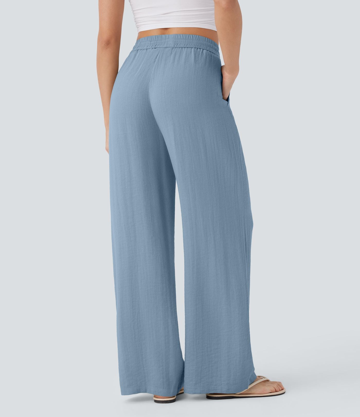 Pantalon large fluide taille haute avec cordon de serrage, poches latérales et aspect lin