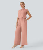 Combinaison pantalon tailleur jambes larges col montant dos goutte d'eau manches courtes avec poches latérales
