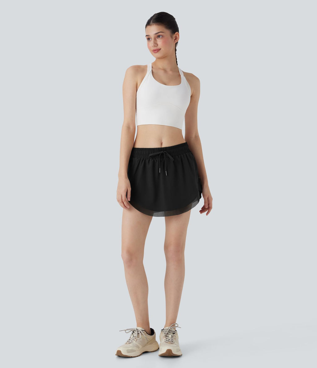 Mini-jupe de tennis 2-en-1 taille moyenne avec cordon de serrage, filet contrasté et poches latérales