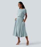 Robe de travail mi-longue fluide gainante à manches chauve-souris avec poches