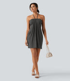 Robe resort mini dos nu à col licou avec lien noué dans le dos et poches