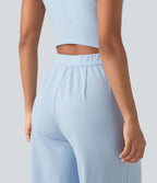 Combinaison tailleur rayée à jambes larges, décolleté en V, découpe et poches