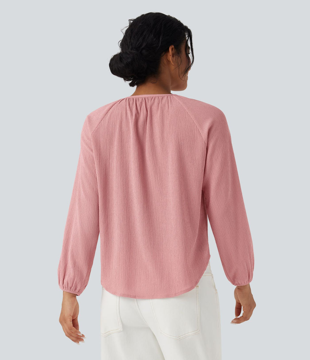 Blouse texturée col rond manches longues ourlet arrondi