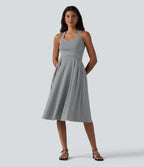 Robe midi fluide sans manches décolleté cœur avec bretelles croisées, nœud dans le dos et poches
