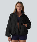 Veste de sport déperlante col montant manches longues zippée avec poches