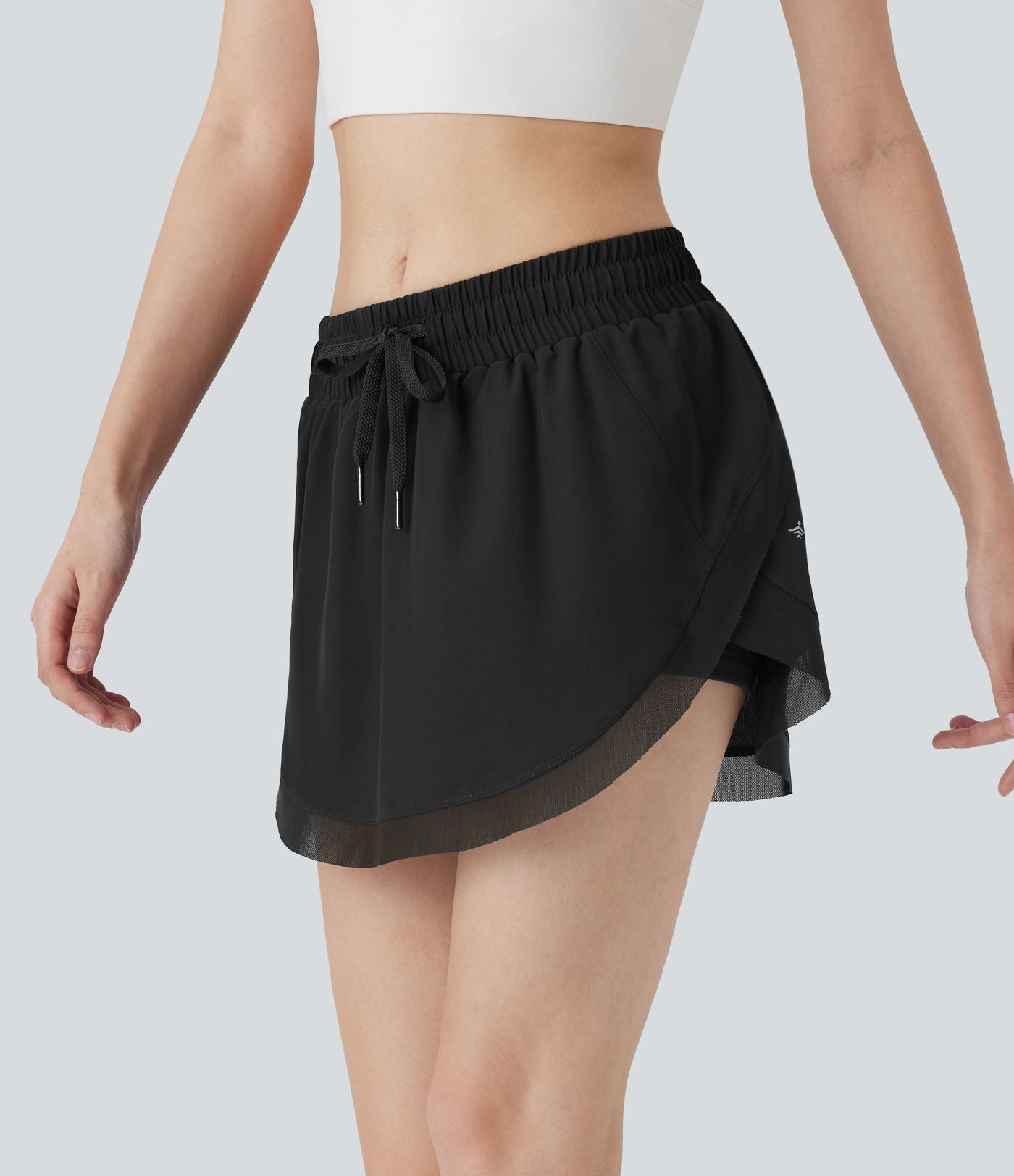 Mini-jupe de tennis 2-en-1 taille moyenne avec cordon de serrage, filet contrasté et poches latérales