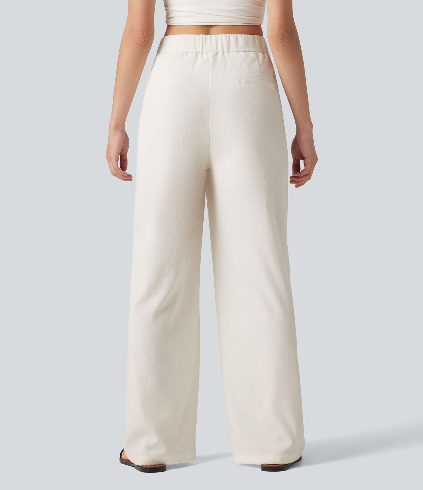 Pantalon large fluide asymétrique taille mi-haute plissé avec poches et aspect lin