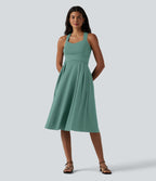 Robe midi fluide sans manches décolleté cœur avec bretelles croisées, nœud dans le dos et poches