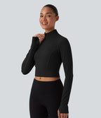 Haut de sport court col cheminée demi-zip manches longues avec passe-pouces