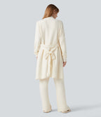Robe d'intérieur longue tricot ouverte ceinturée manches longues avec poches