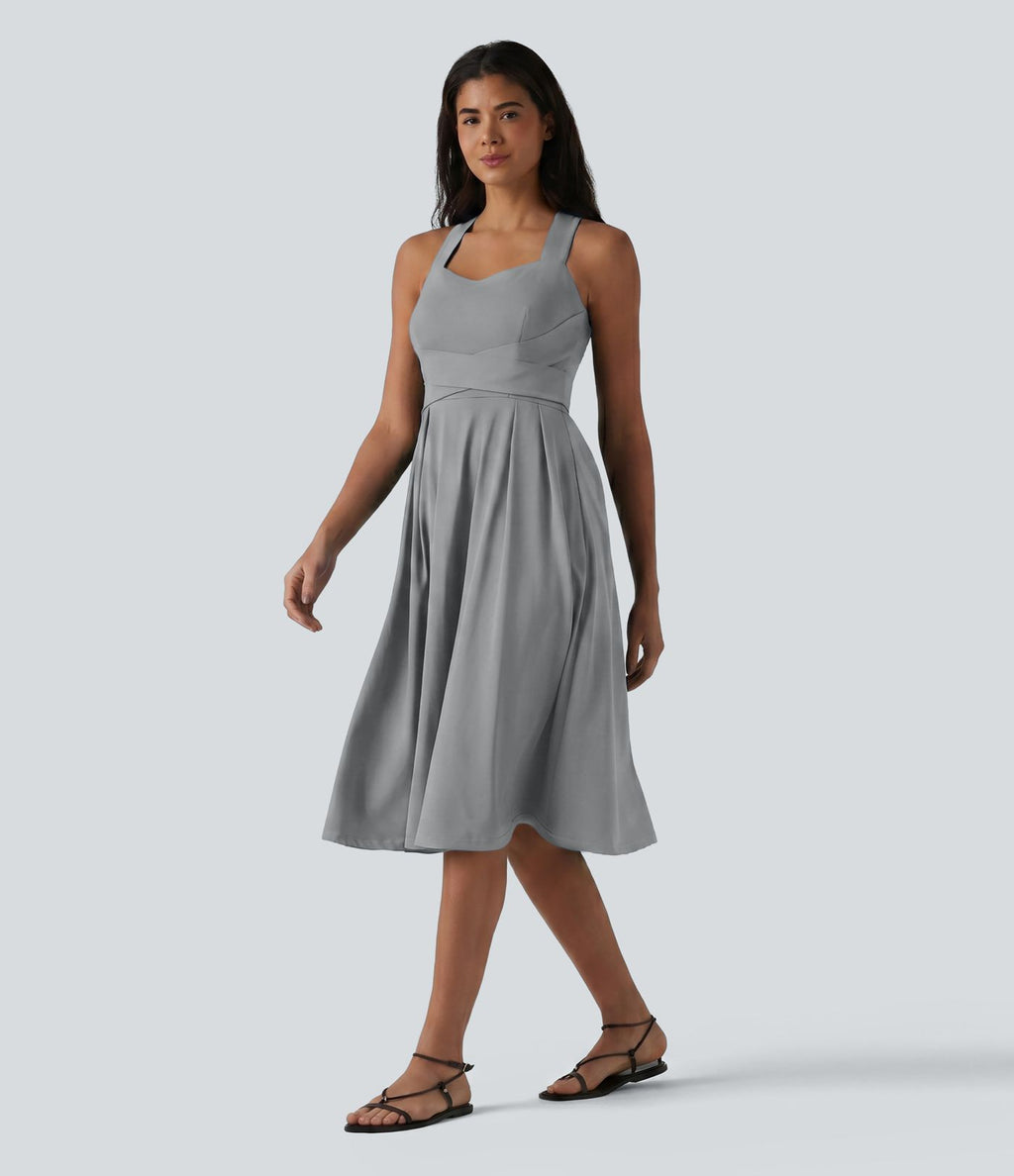 Robe midi fluide sans manches décolleté cœur avec bretelles croisées, nœud dans le dos et poches