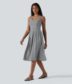 Robe midi fluide sans manches décolleté cœur avec bretelles croisées, nœud dans le dos et poches