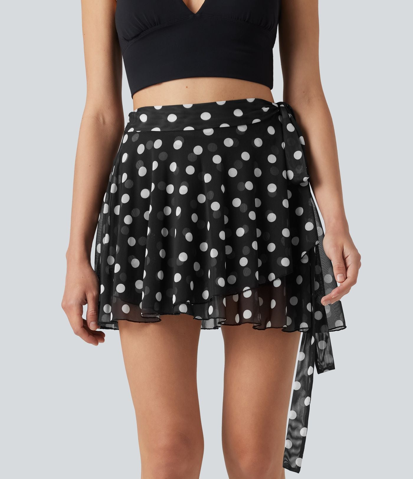 Jupe évasée micro-mini en maille à pois, taille haute, à nouer sur le côté et poche