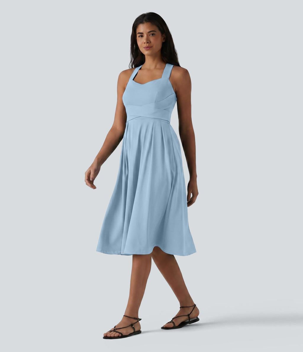 Robe midi fluide sans manches décolleté cœur avec bretelles croisées, nœud dans le dos et poches