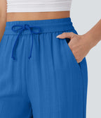Pantalon large fluide taille haute avec cordon de serrage, poches latérales et aspect lin