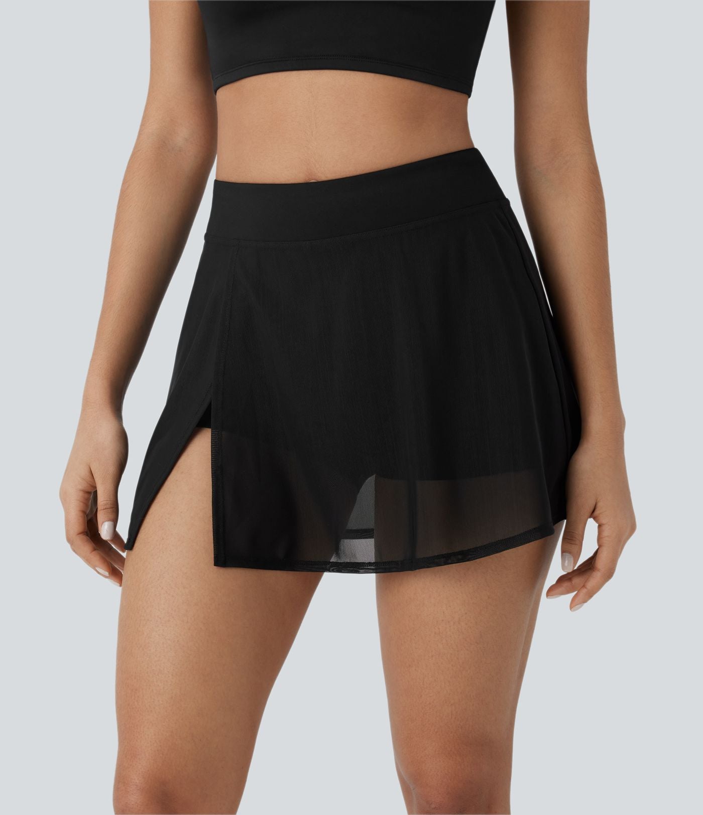 Mini-jupe de yoga taille haute avec short intégré, poches latérales et empiècements en maille contrastée avec fentes