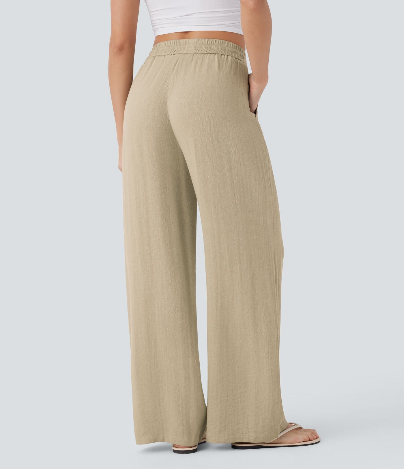 Pantalon large fluide taille haute avec cordon de serrage, poches latérales et aspect lin
