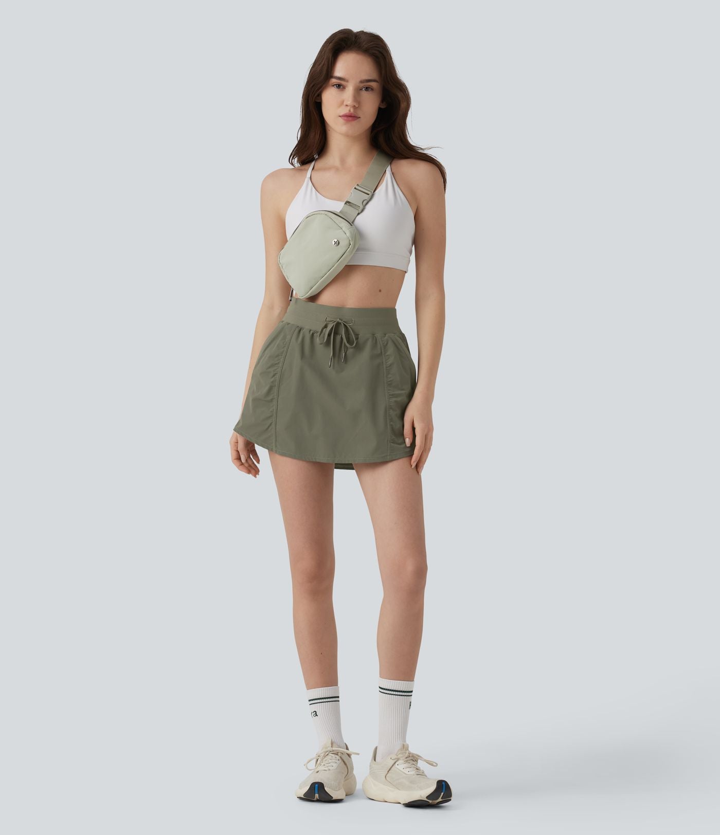 Jupe de sport mini 2-en-1 taille haute coupe trapèze avec cordon de serrage et poches