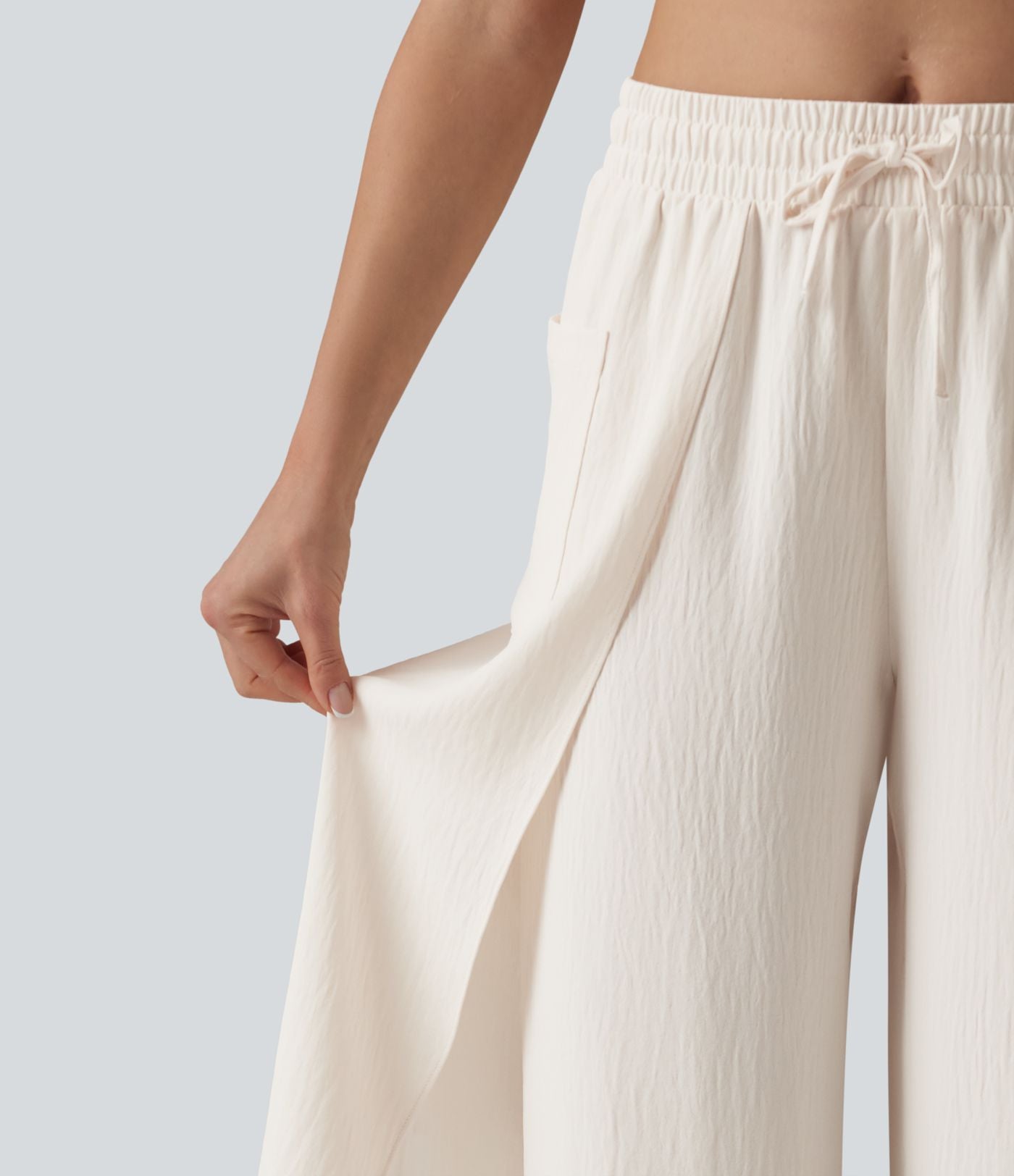 Pantalon ample décontracté à taille mi-haute, fentes, aspect lin, cordon de serrage et poches