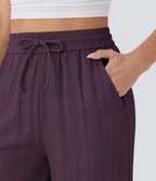 Pantalon large fluide taille haute avec cordon de serrage, poches latérales et aspect lin